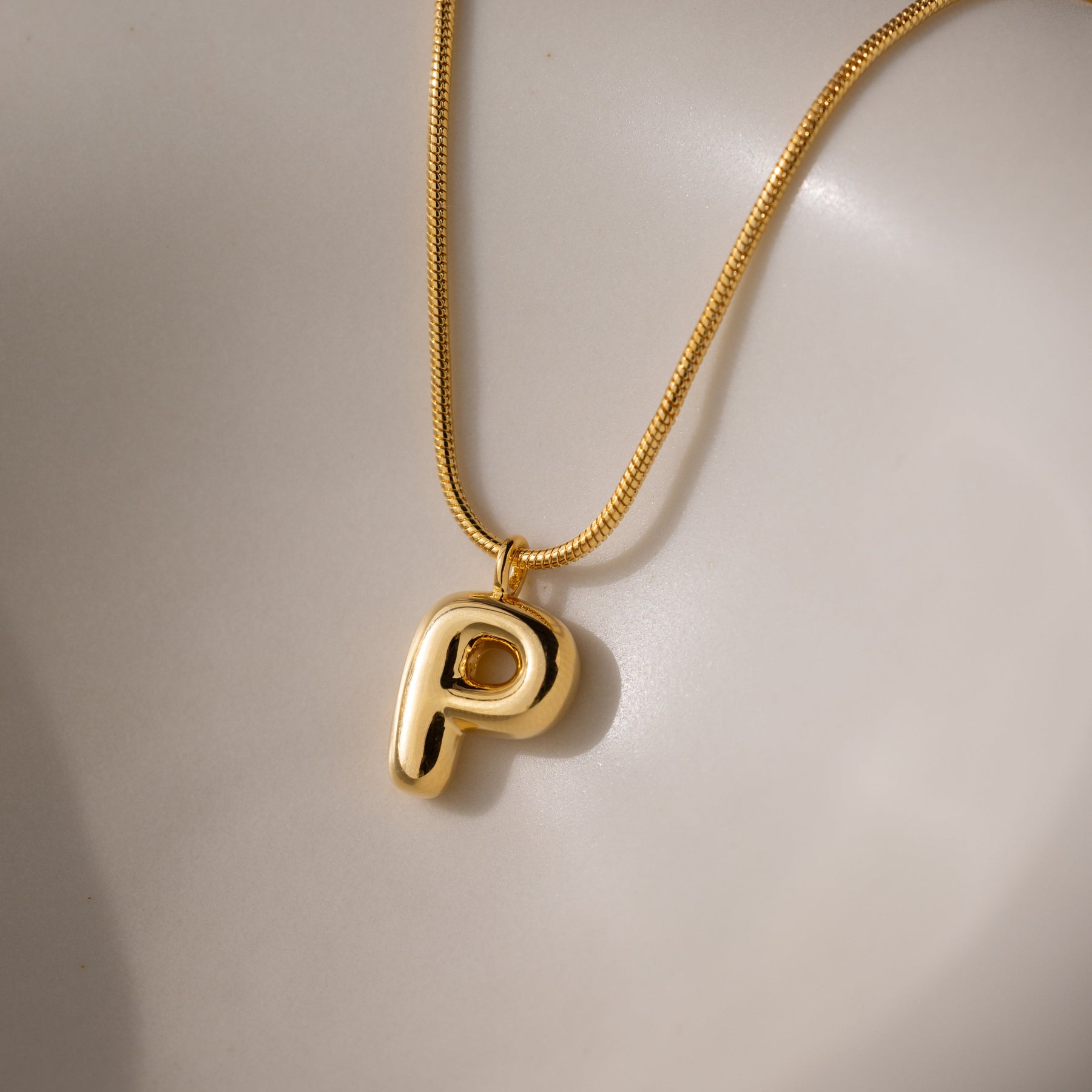 Colar com pingente de letra em formato de bolha